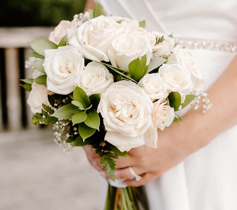 This beautiful gathering of blush and white roses are accented softly with