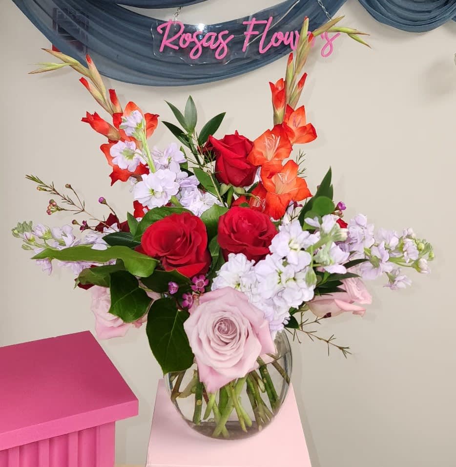 A brilliant arrangement featuring 6 red roses, 6 pink roses, Glaminis, Stock