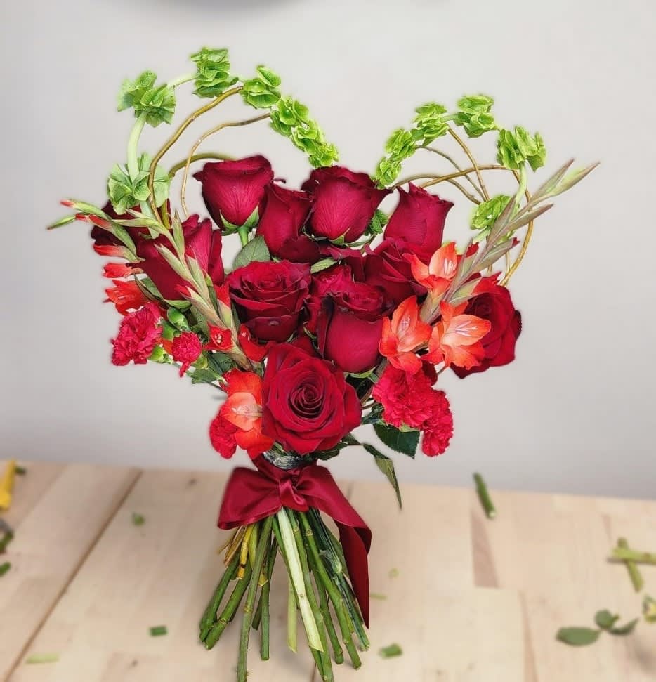 A gorgeous bouquet of roses, stock and glaminis with a heart shaped