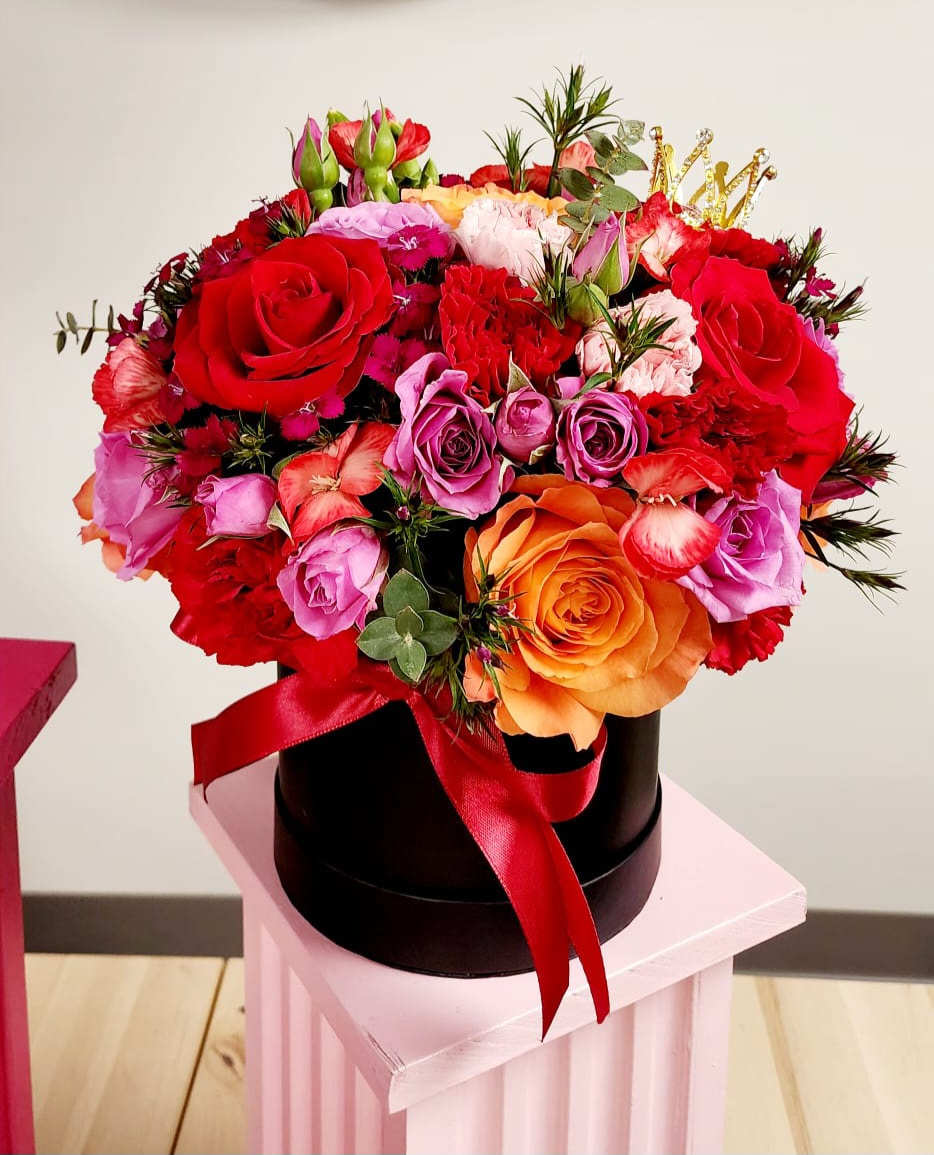 A stunning arrangement with a mixture of flowers including Roses, spray roses