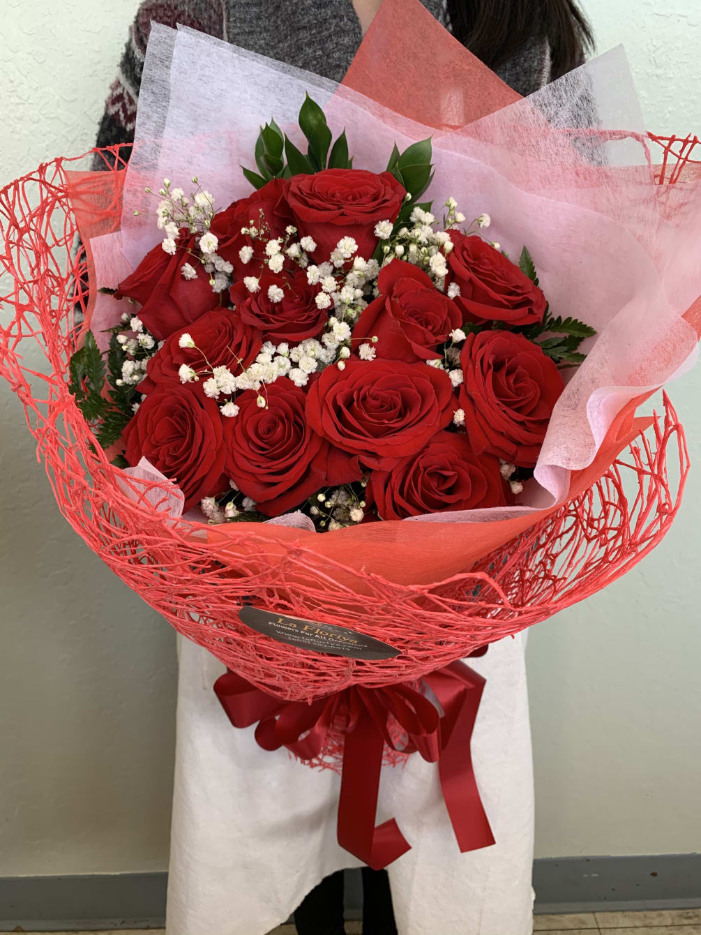 Lovely hand tied Red Roses wrapped bouquet with baby&#039;s breath and filling