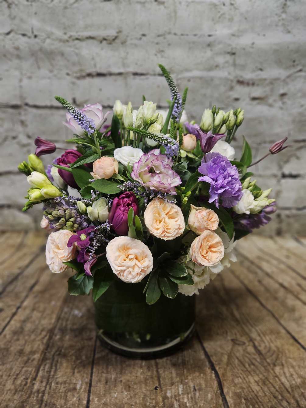 A dense composition of fragrant spring flowers such as hyacinth and freesia