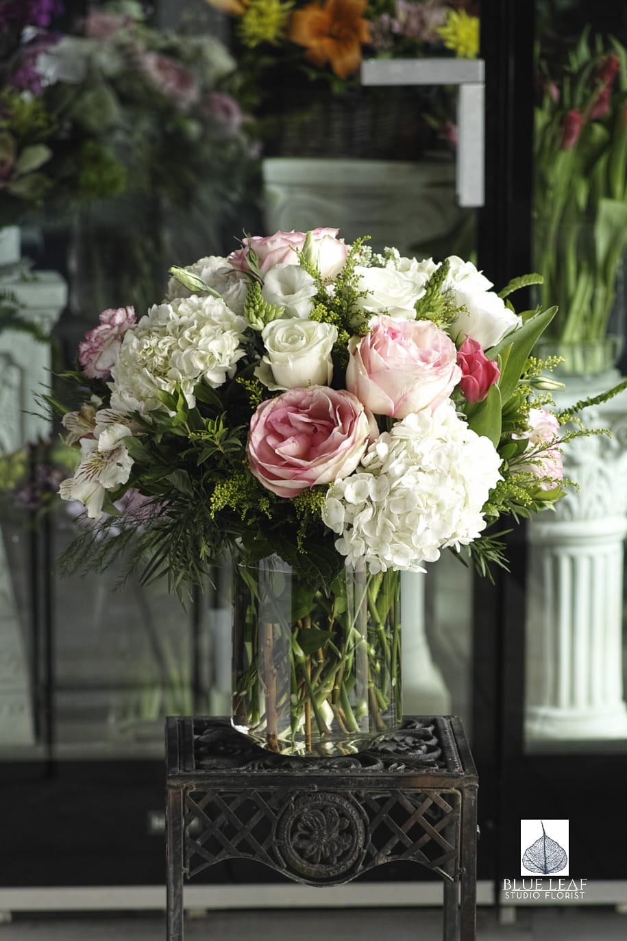 A bountiful arrangement of garden favorites: hydrangeas, roses, carnations, and alstromeria. An