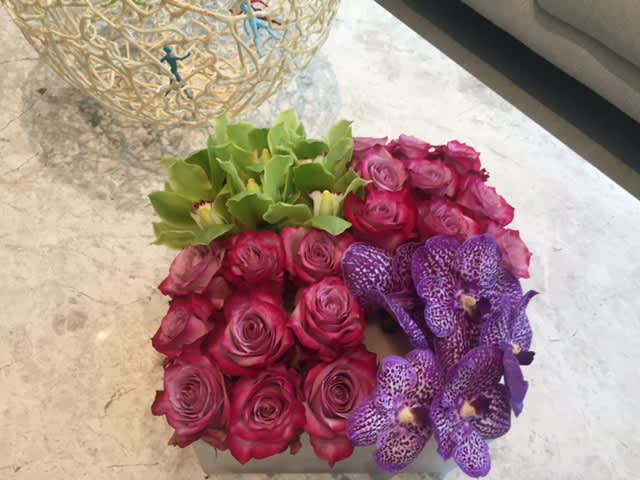purple roses accented with orchids