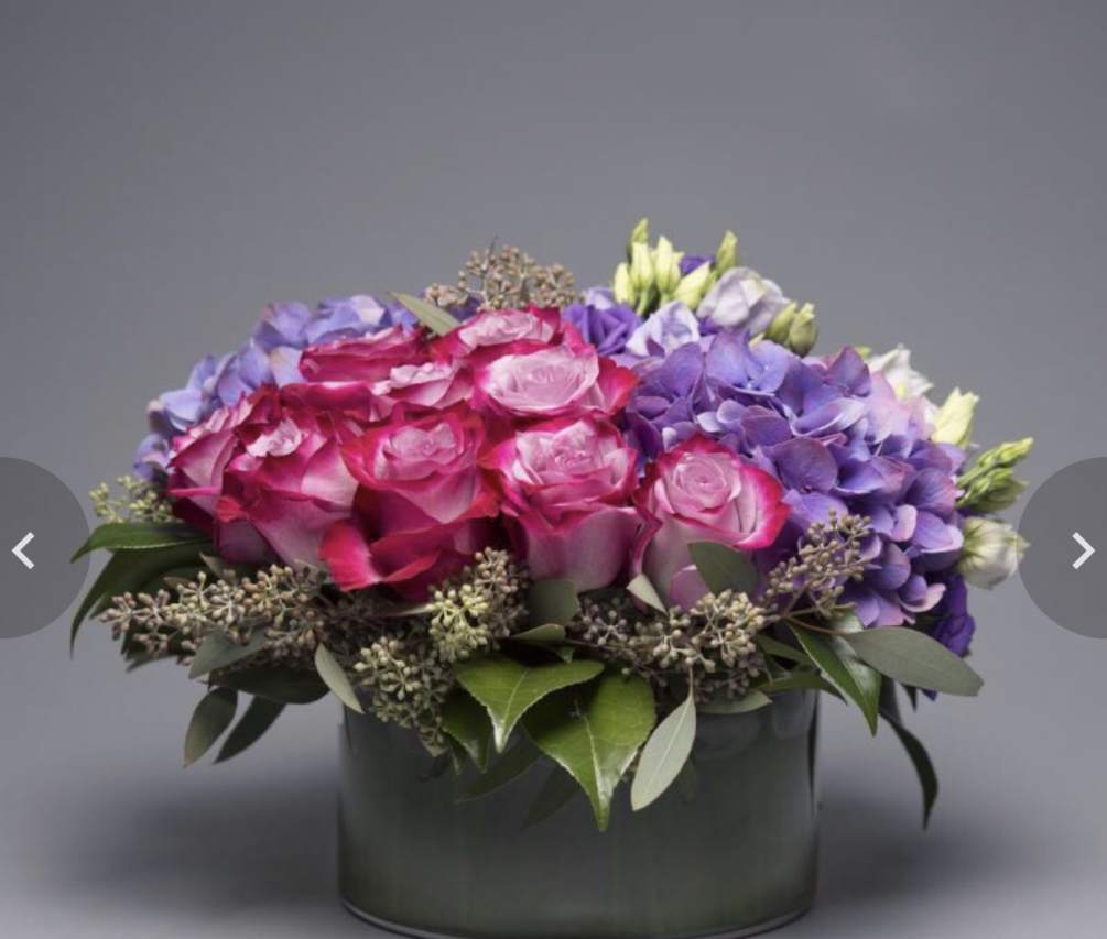 purple roses accented with purple hydrangeas