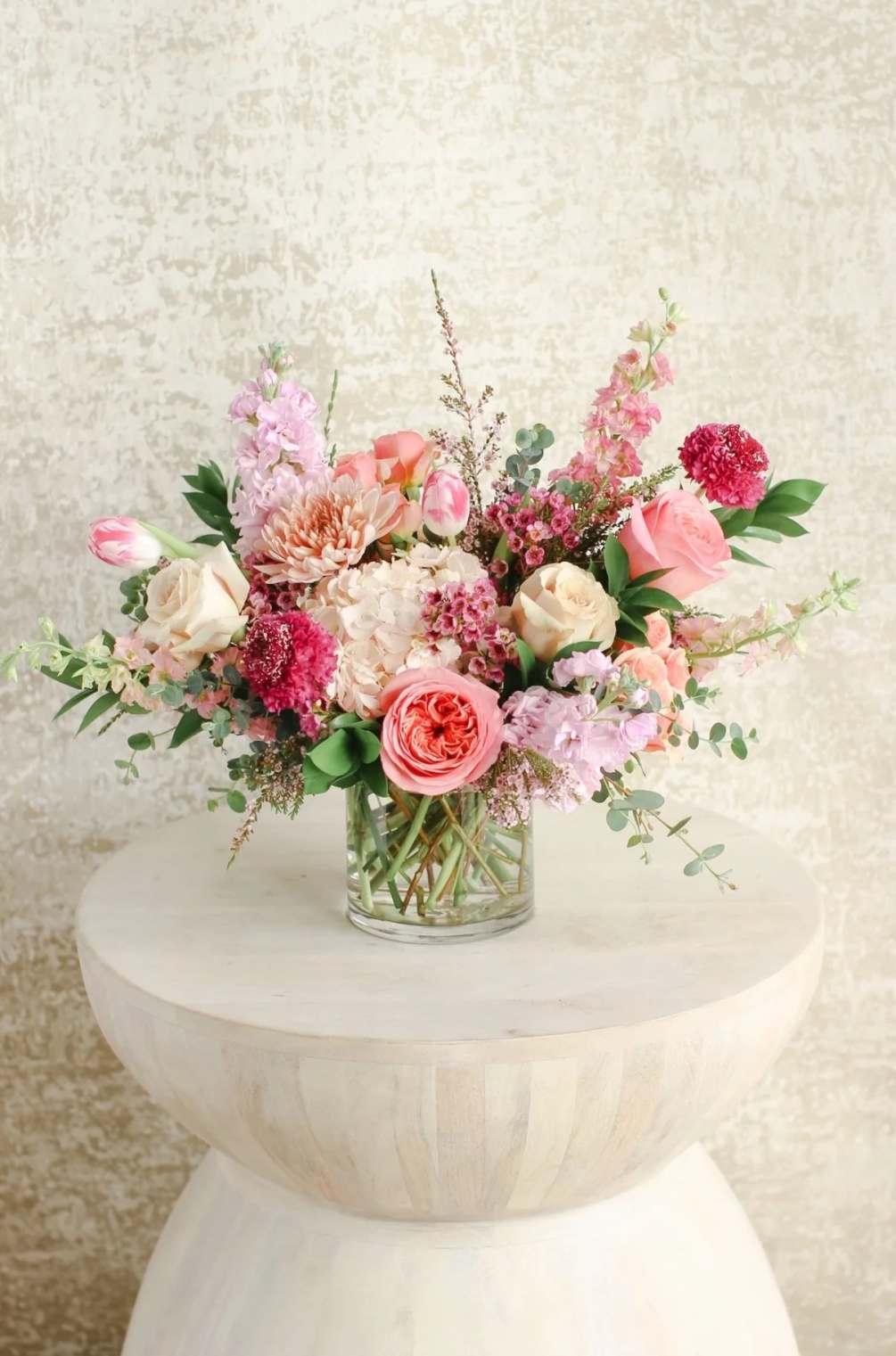 A textural fun arrangement designed in various shades of pink. Perfect to