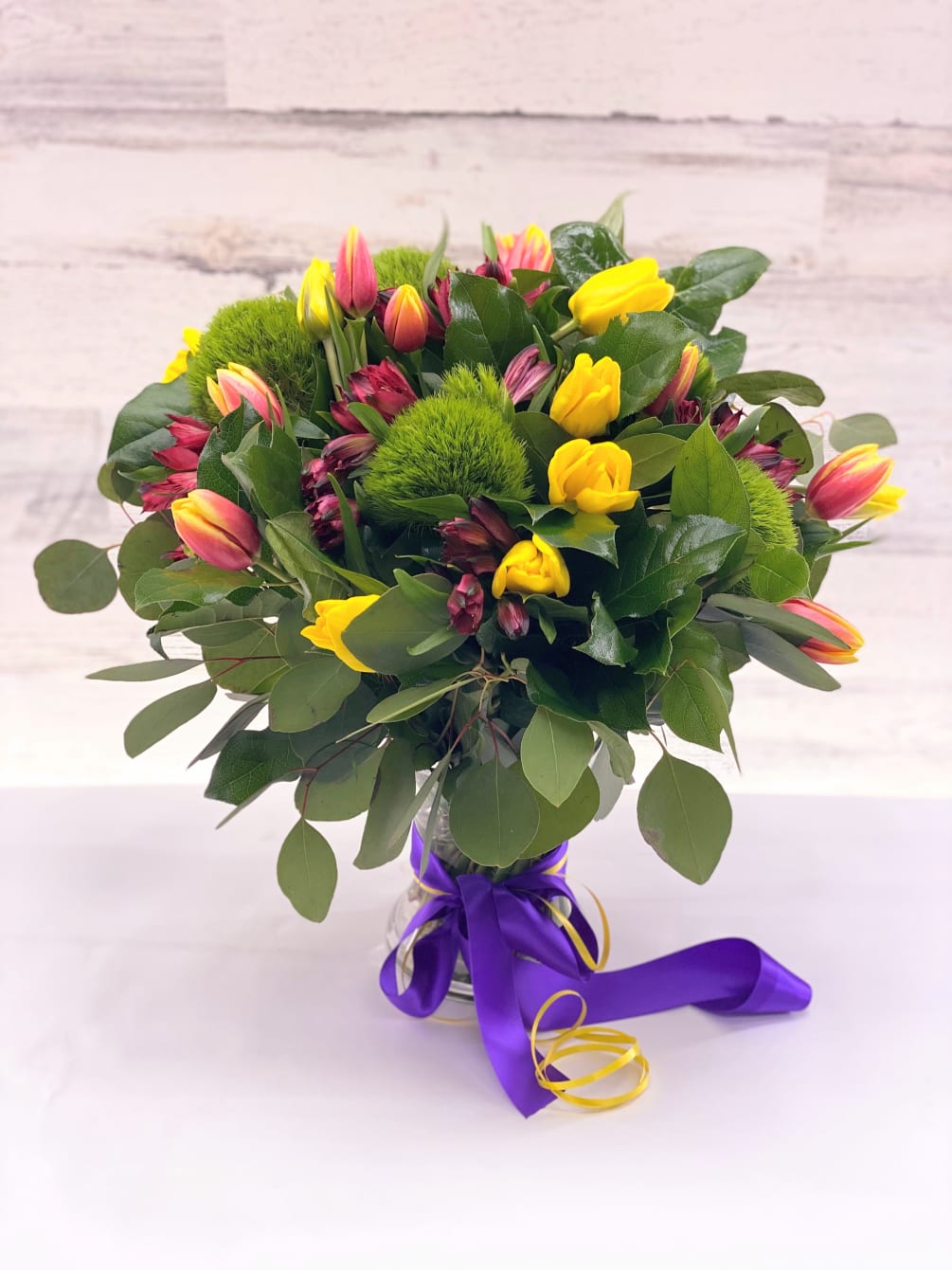 A composition of tulips of yellow and orange in a bouquet with