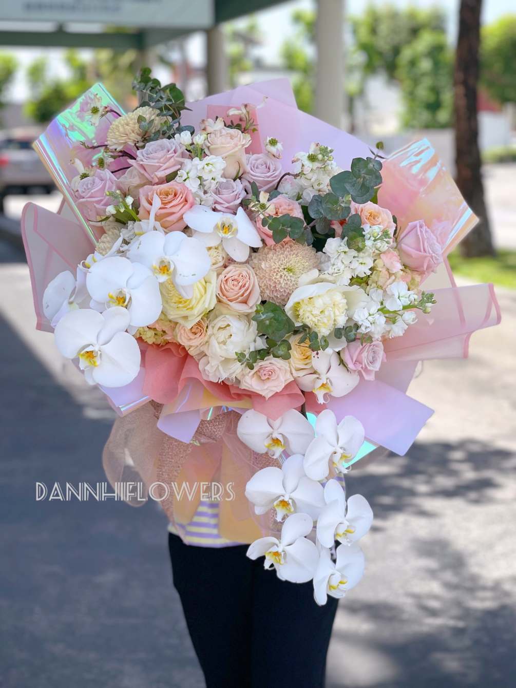 a Pastel mix bouquet with the highlight of white phalaenopsis. The cascading
