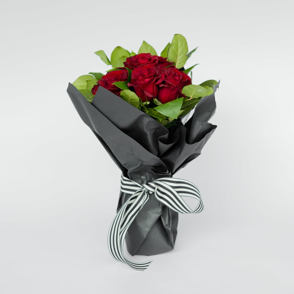 A true classic that everyone loves! Red roses wrapped in black paper.