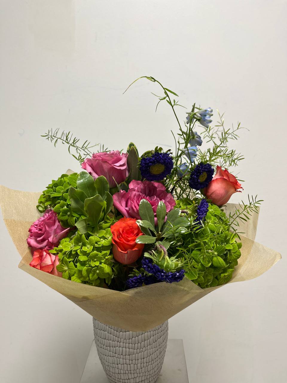 hand tie wrapped bouquet displayed in a vase