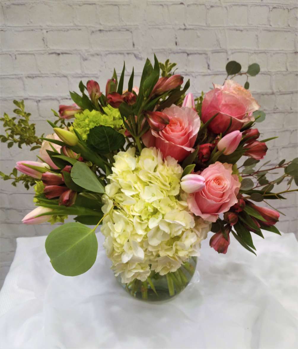 Beautifully styled design featuring pink flamingo roses, white hydrangea, long lasting pink