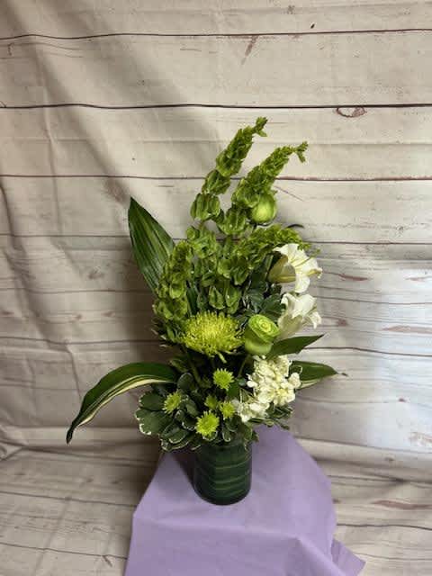 A mixture of Bell&#039;s of Ireland, white hydrangea, white lily, white or