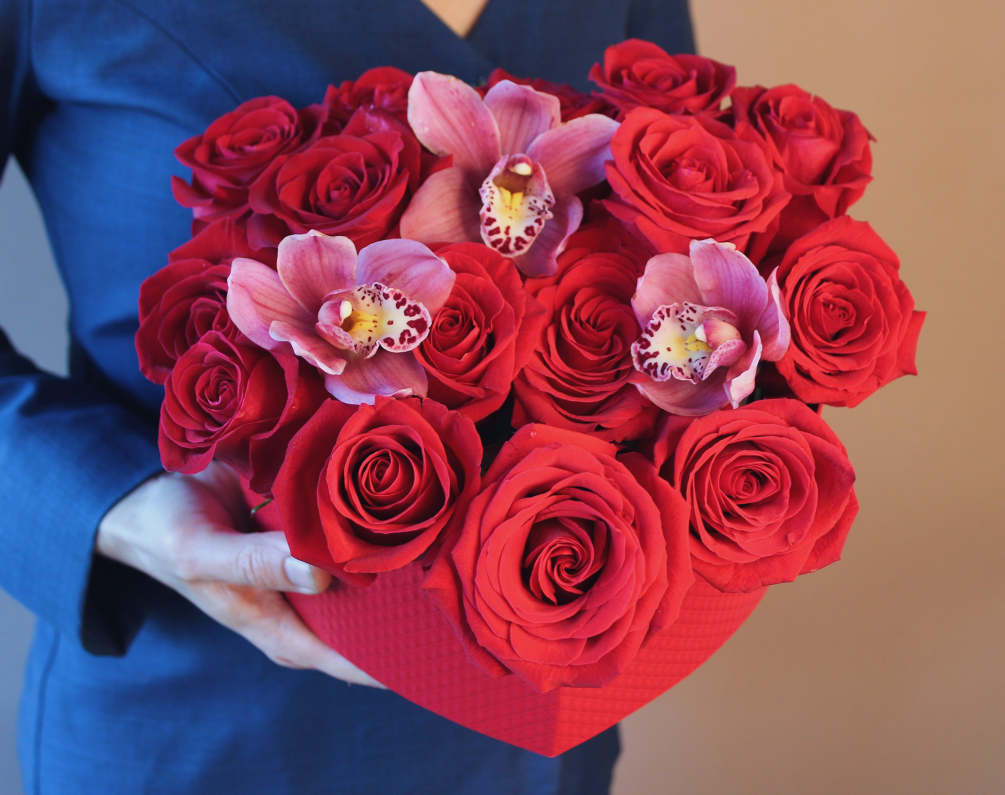 Red roses and orchids in our hand-crafted red heart-shaped box. There&rsquo;s no
