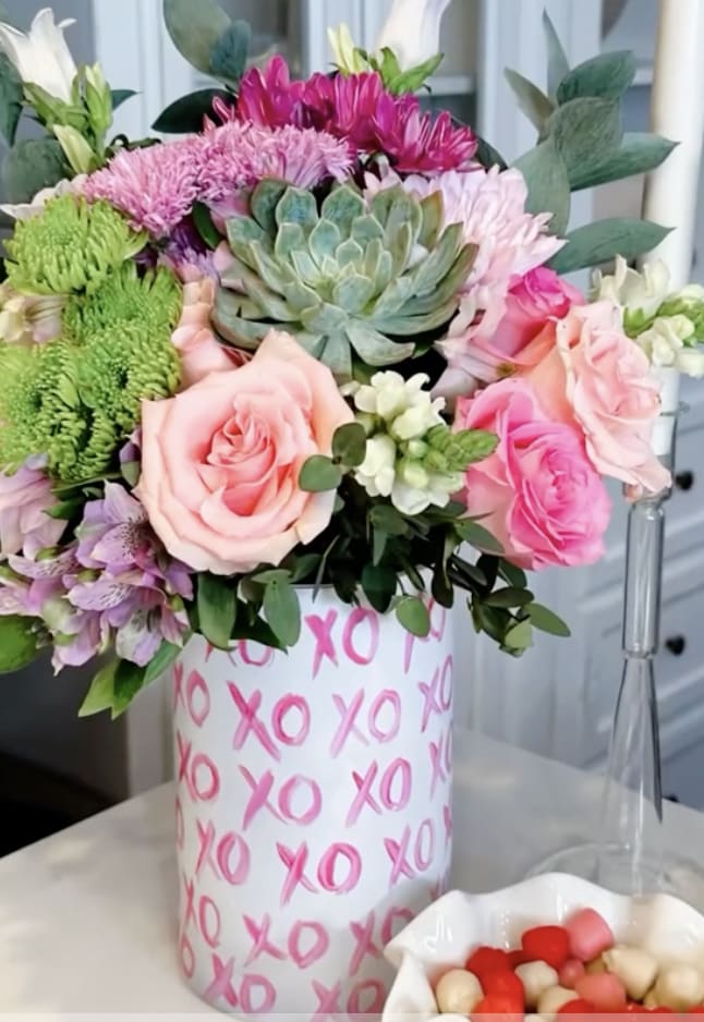 A tall, large handmade ceramic vase painted with X&#039;s and O&#039;s all