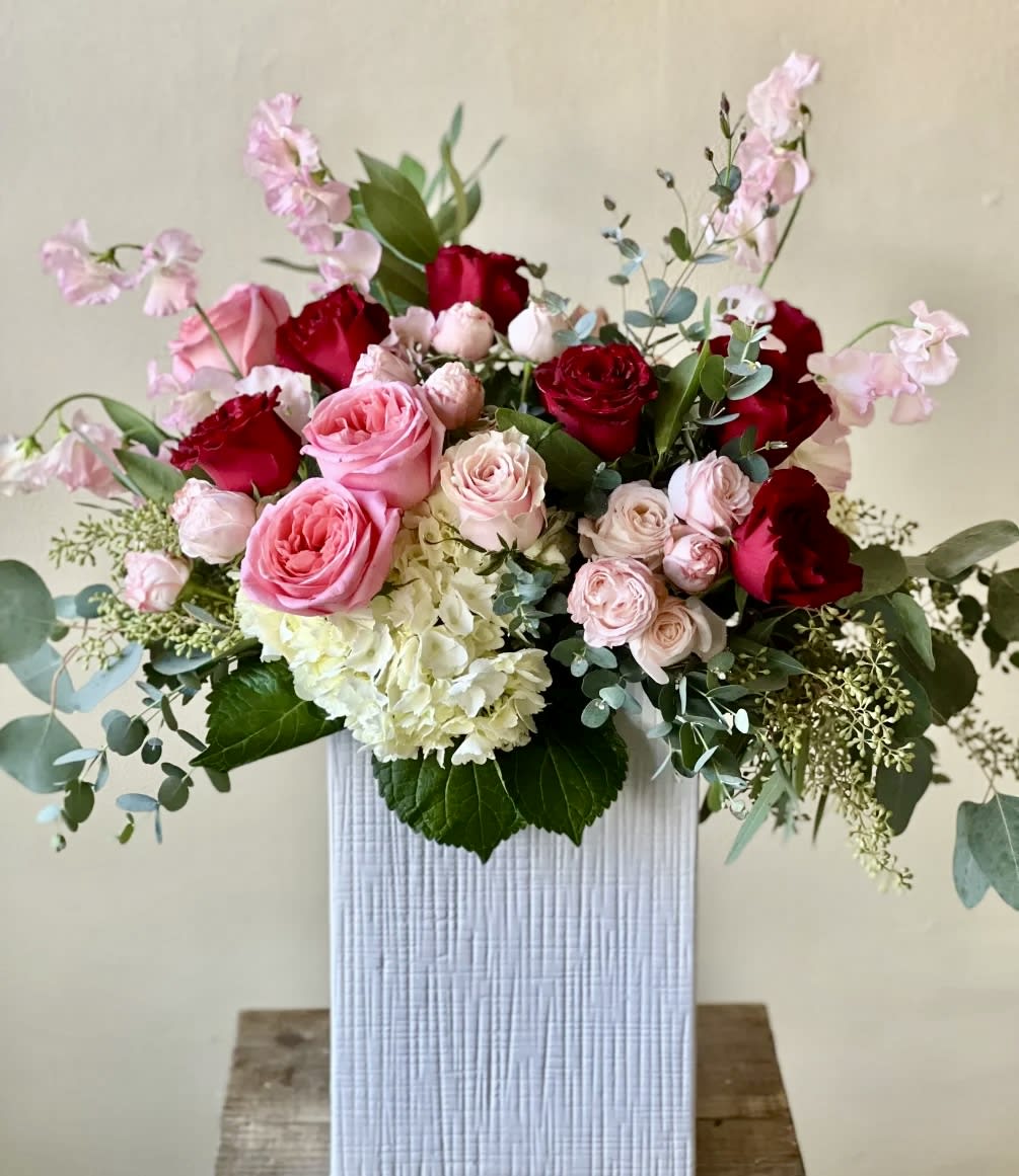 Tall and romantic arrangement that includes white, red and pink blooms.
Dimensions approximately: