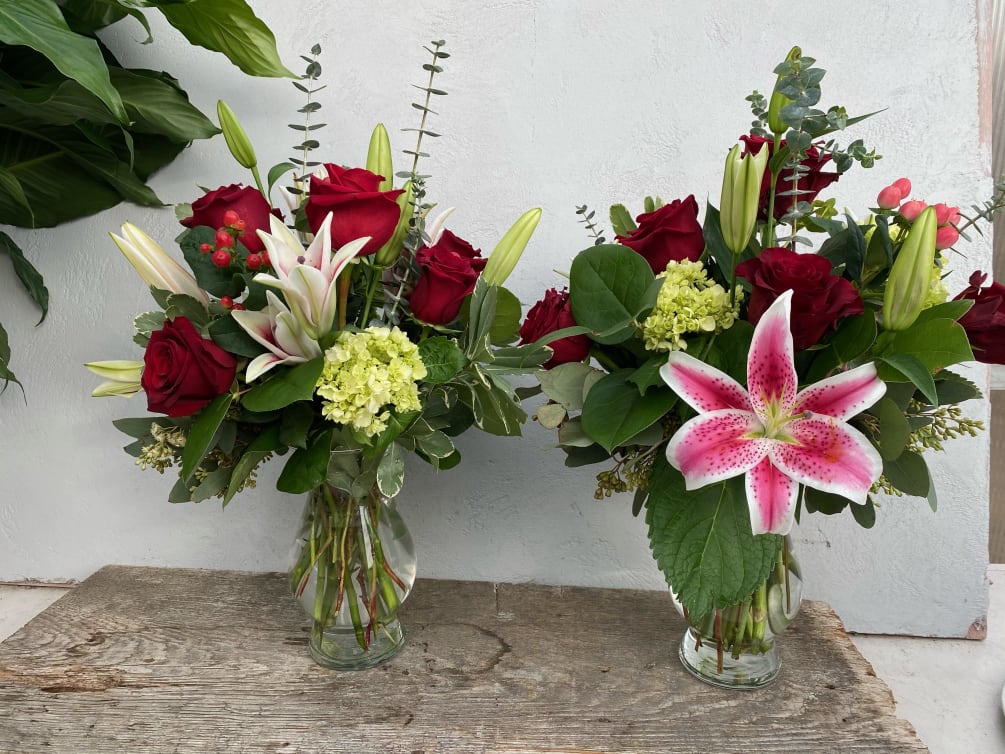 A lovely arrangement of red roses, starfighter lilies, and mini green hydrangea