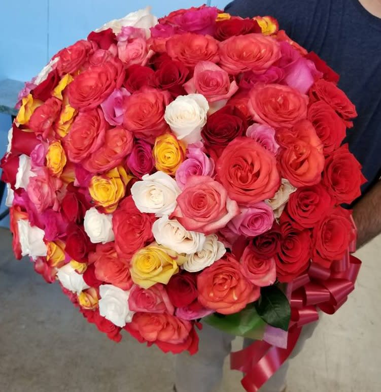 50 Colorful delicious and fresh roses tide together in a bouquet.
Colors depending