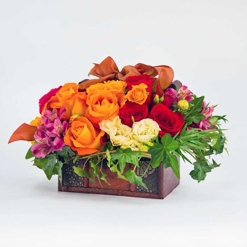 A colorful array of roses and others, surrounded with green ivy in