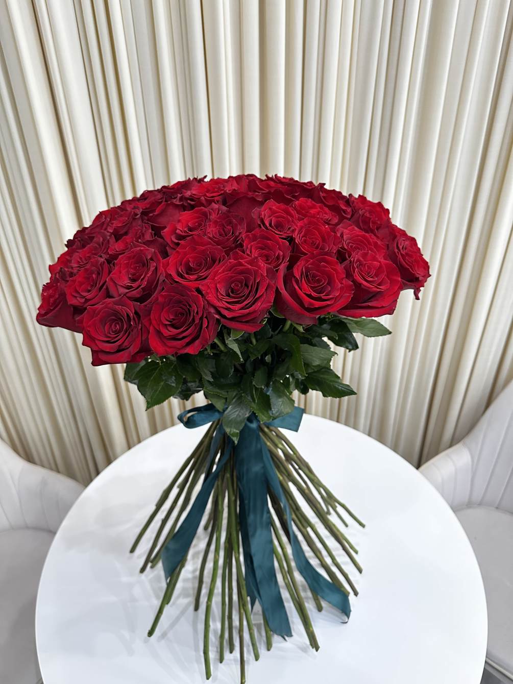 This captivating spiral bouquet of 50 red roses is the perfect way