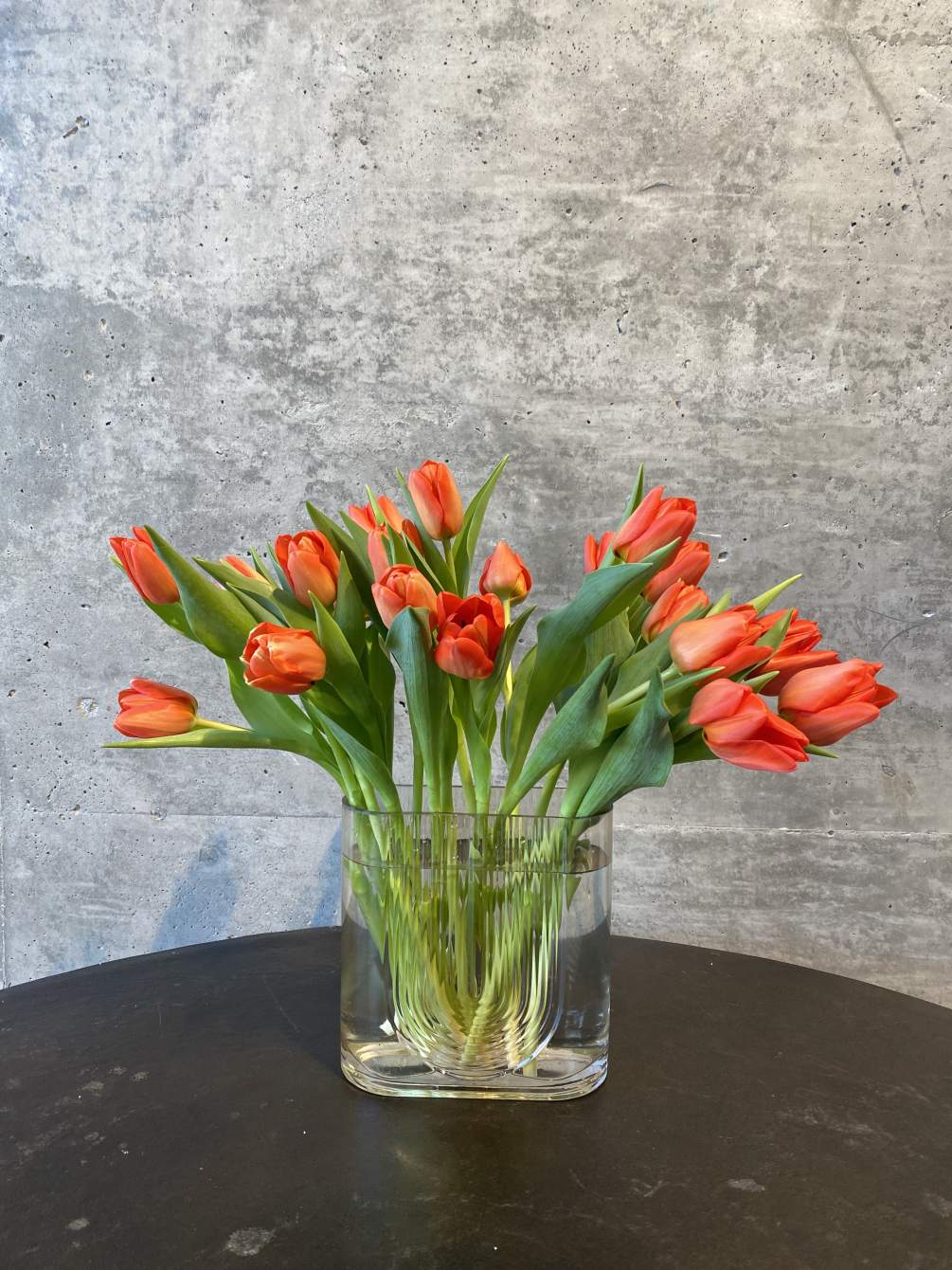 20 tulips placed elegantly into an elevated vase. Please specify color when