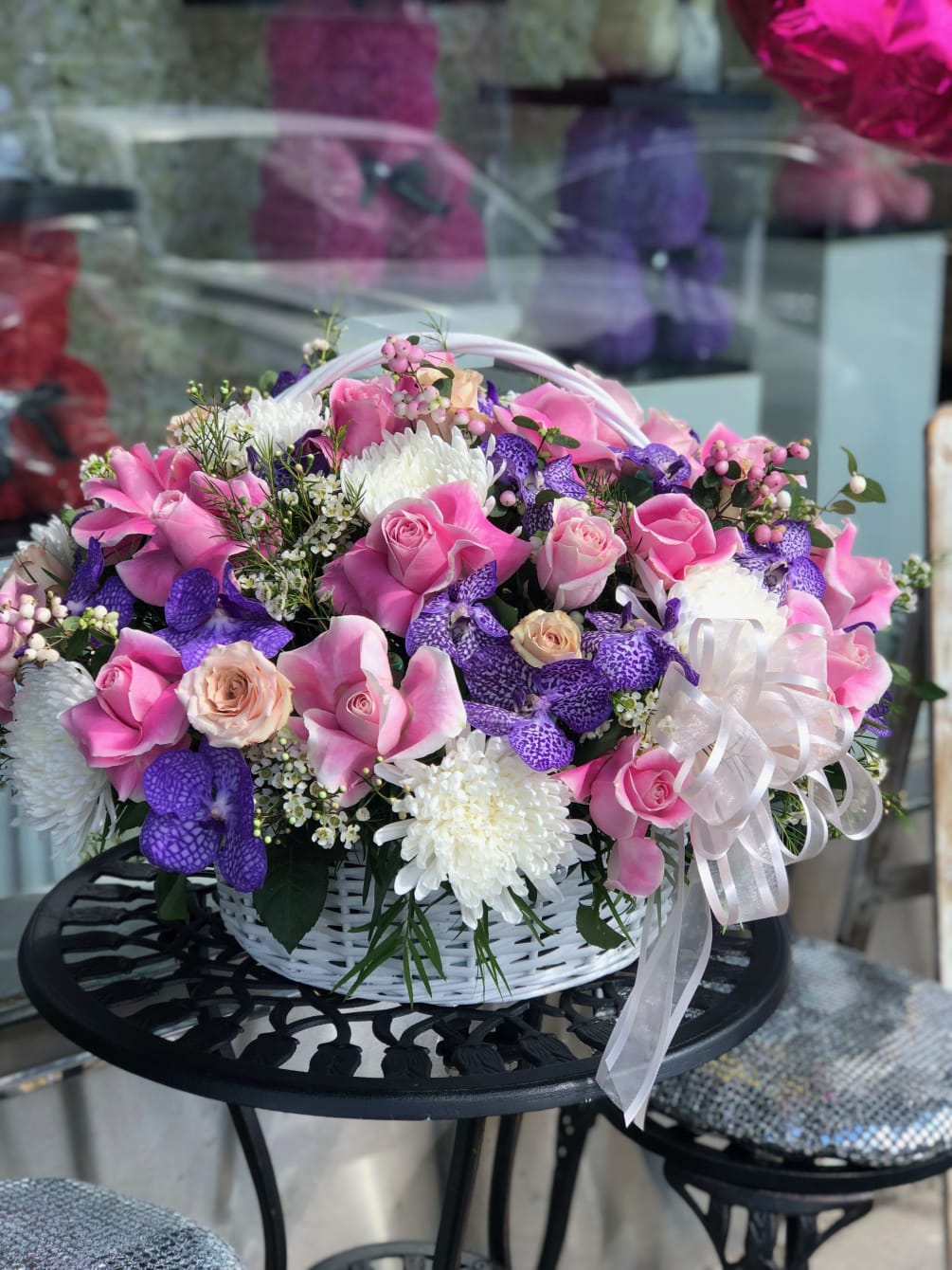 A FULL BASKET WITH MIXED ROSES ,VANDA ORCHIDS,ROSES AND SPRAY ROSES 
