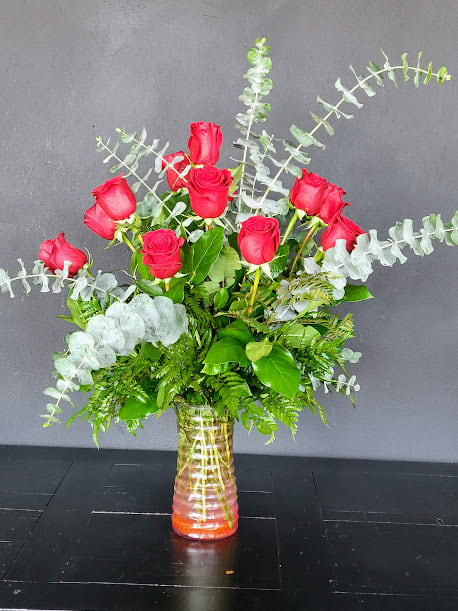 This dozen of gorgeous red roses are enhanced by fragrant baby eucalyptus