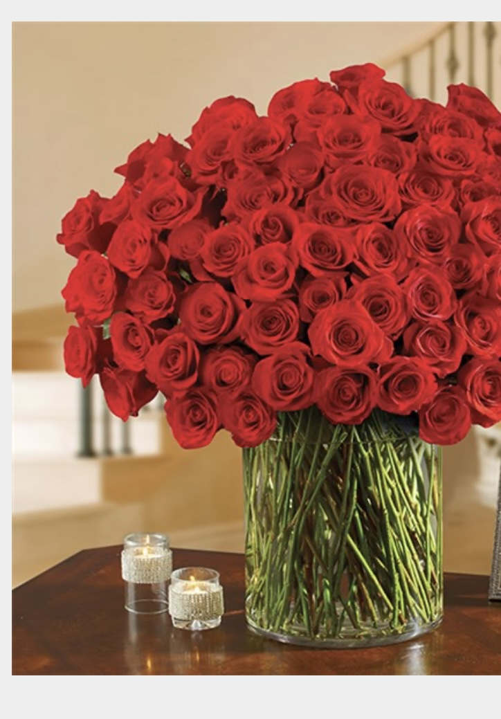 Beautiful 100 roses designed in oversized cylinder vase. 
