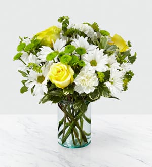 With yellow roses, white daisies and green button poms, the Happy Day