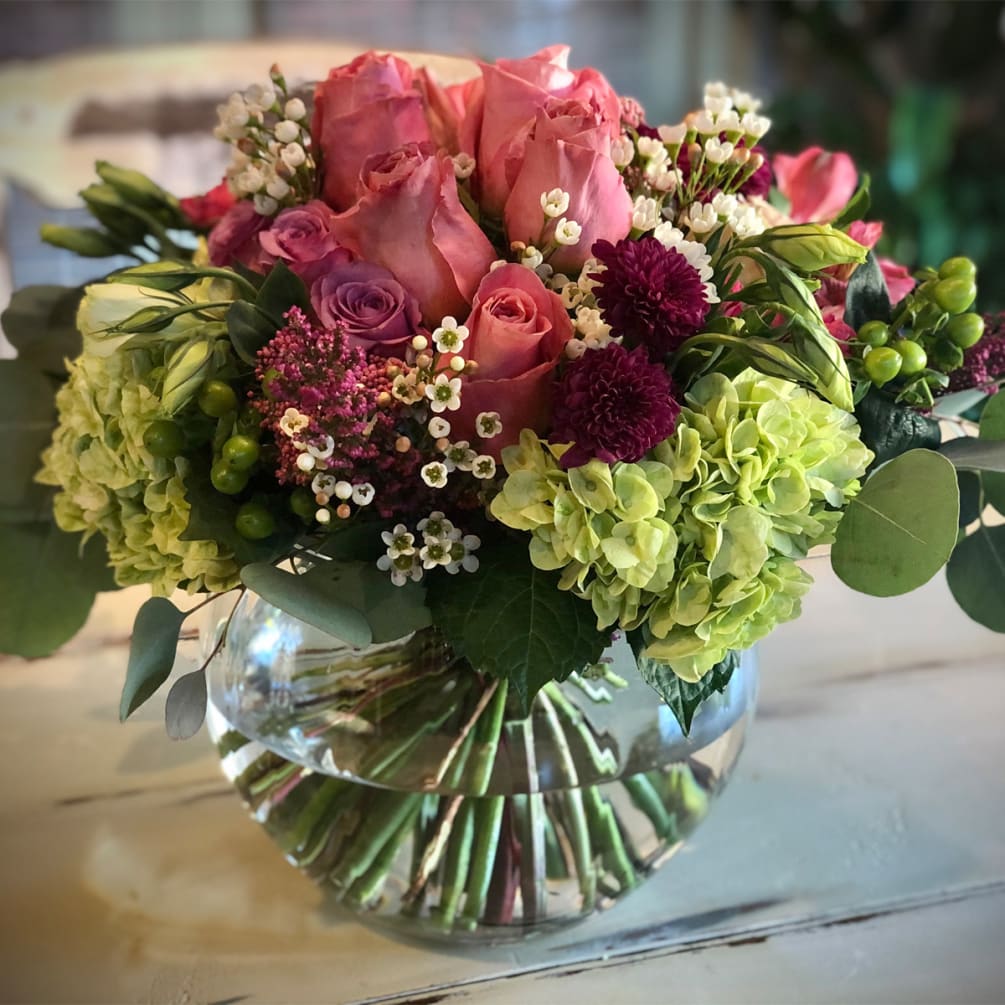 Beautiful modern bouquet with large pink roses, purple roses, tulips, green hydrangeas