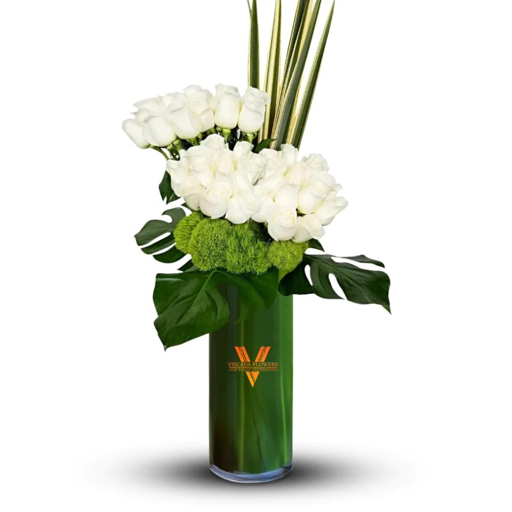 A serene bouquet featuring pristine white roses elegantly intertwined with lush greenery.