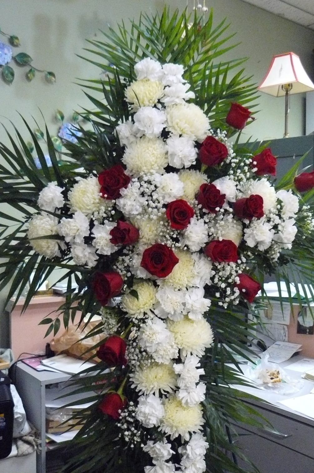 Pictured is a  Cross  designed with  Mums, Spiders, Roses