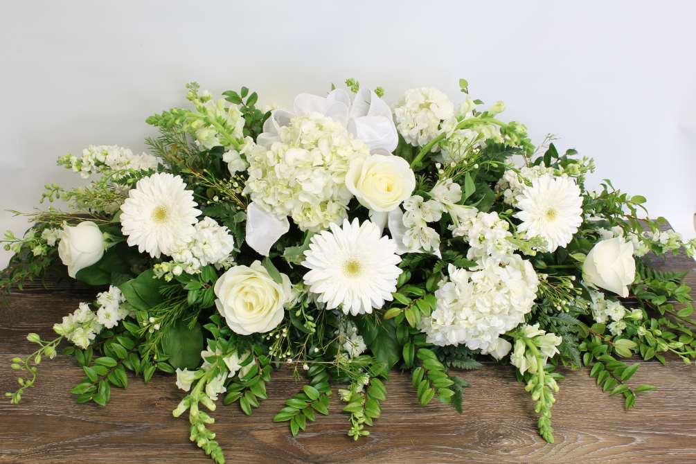This casket spray is filled with a garden mix for elegant all