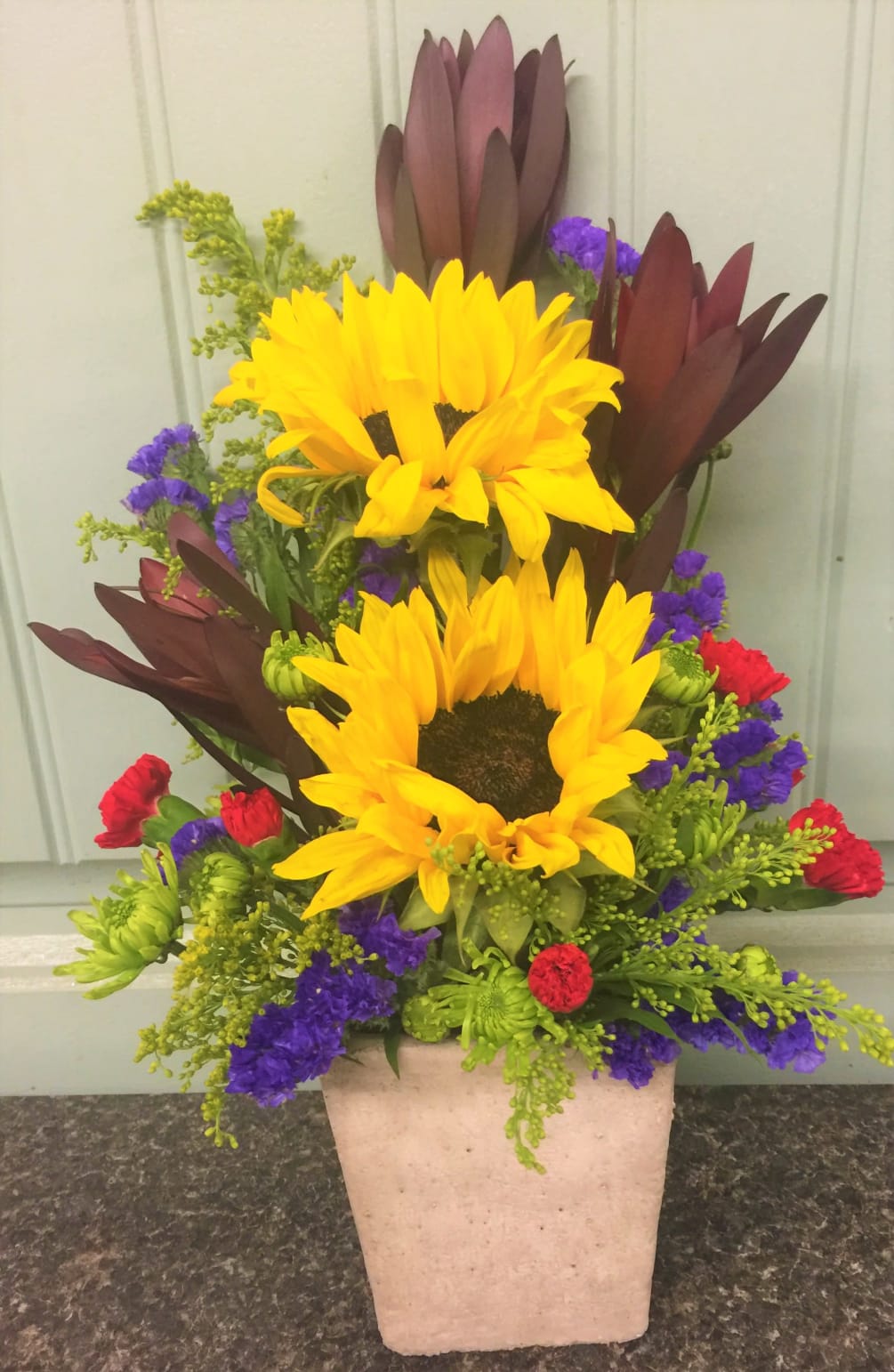 sunflowers , safari sunset, red mini carnations accented with yellow solidago and
