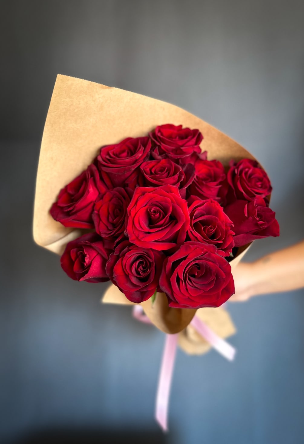 A gorgeous assortment of premium red roses in a hand tied Bouquet.