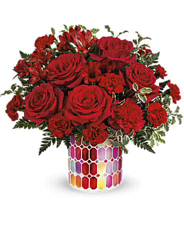 Red roses, carnations and alstroemerias in mosaic container.