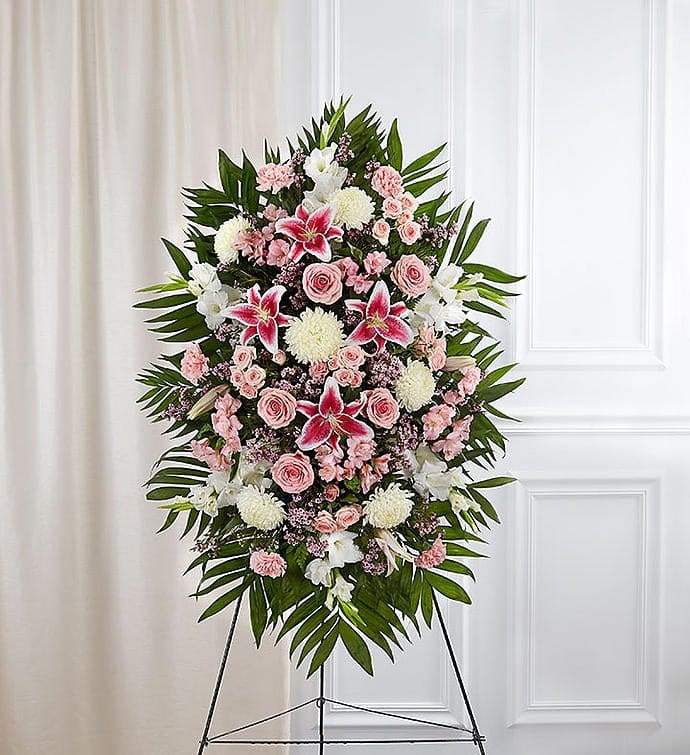 Assorted Pink and White flowers arranged on a standing easel for the
