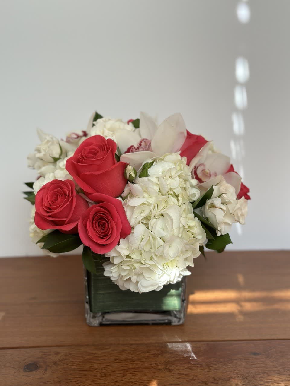 Classic and Beautiful, this arrangement whispers luxury. Pinks, whites and creams come
