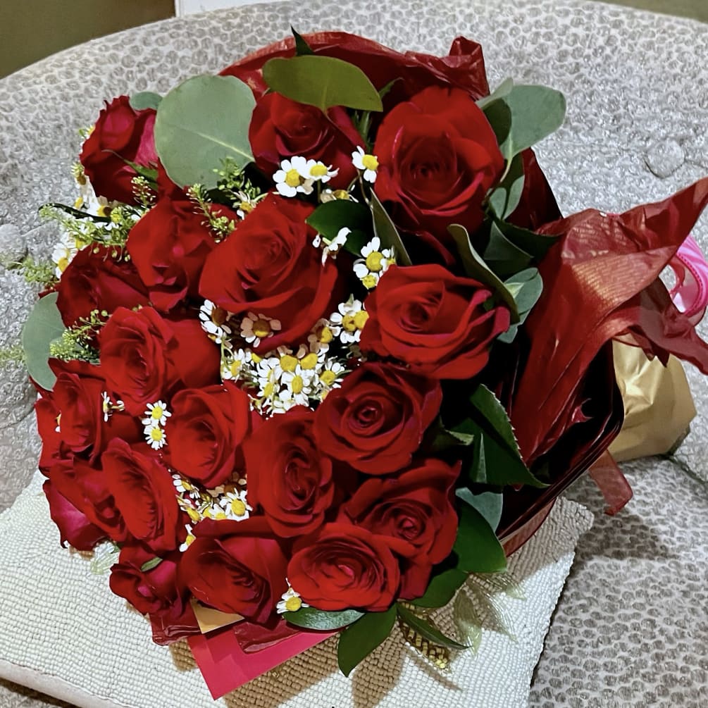 Elevate the moment with our stunning Two Dozen Wrapped Red Roses Bouquet.
