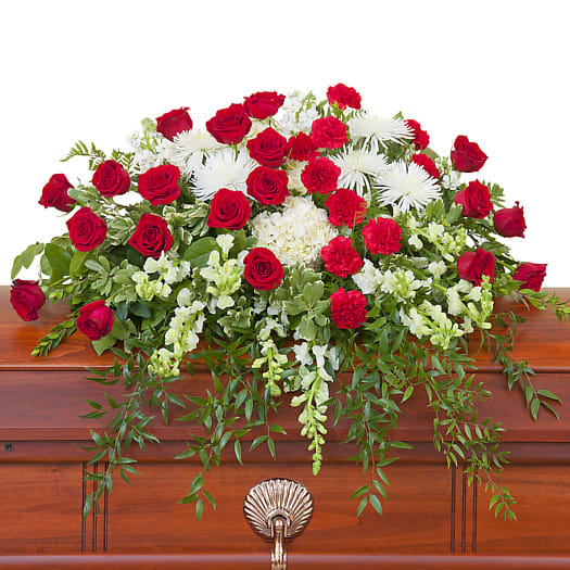 Red and white premium varieties of roses and seasonal flowers combine with