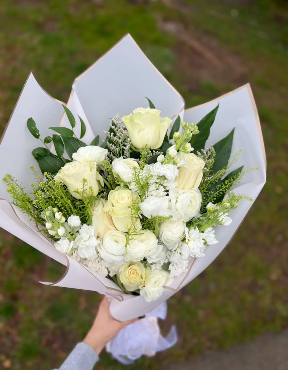 Hand wrapped bouquet, Featuring a simple eye catching white mixed flower bouquet