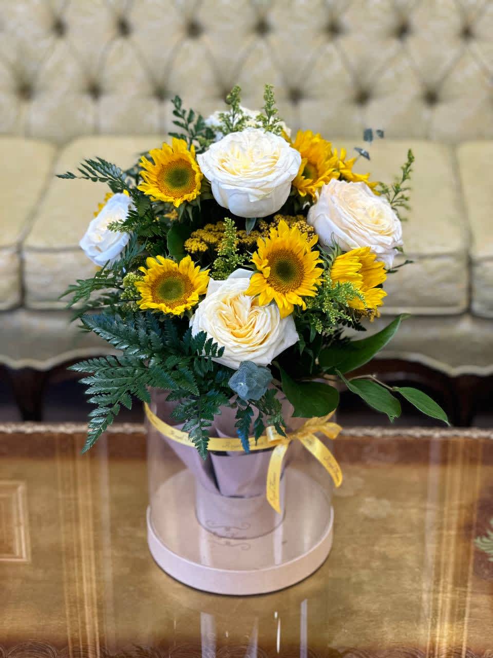 Fragrant Candlelight roses, bright and vibrant sunflowers and unique filler flowers are