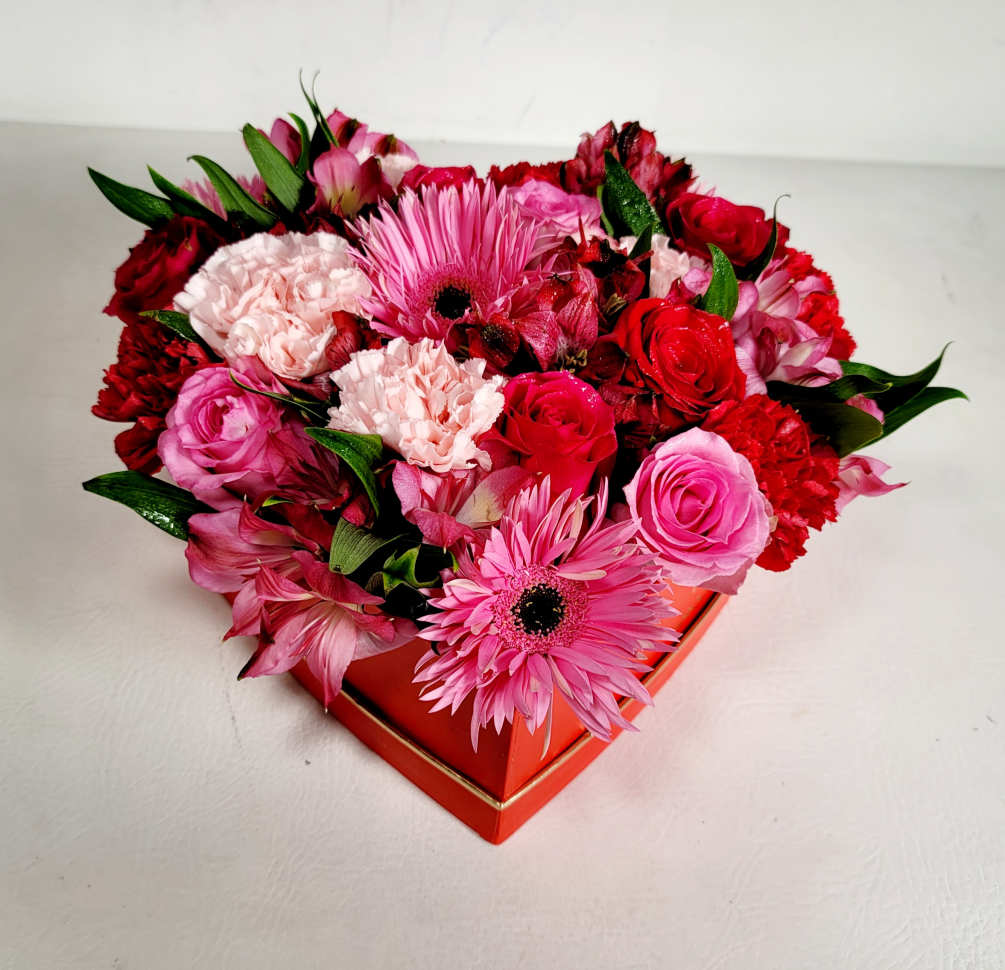 This fun and beautiful arrangement typically includes: Red roses, Pink Roses, Pink