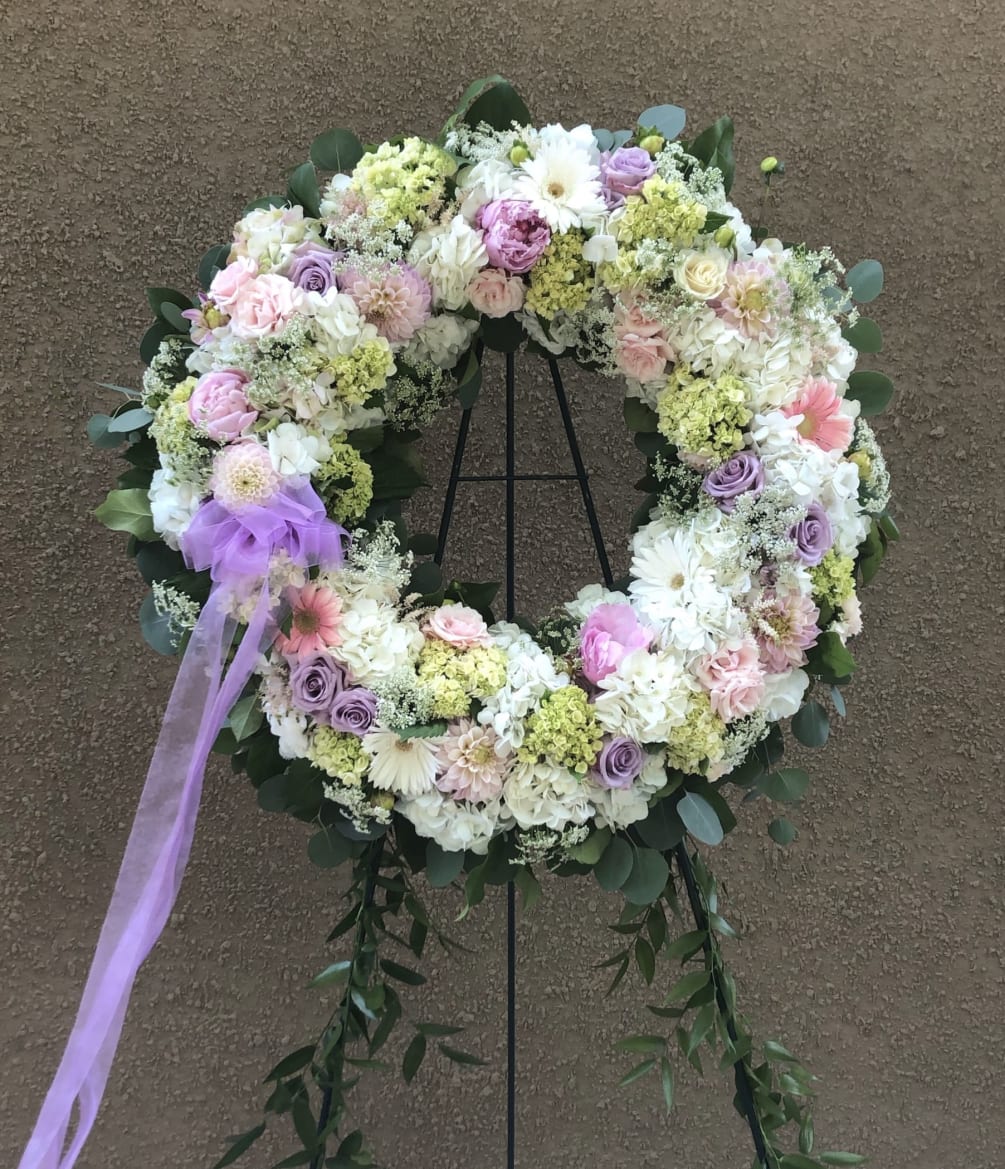 Assorted florals combine to make a lovely tribute presentation.  Please feel