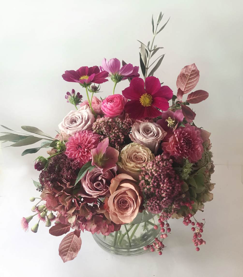 A natural and stylish, rustic arrangement of golden blush, dusty colors, and