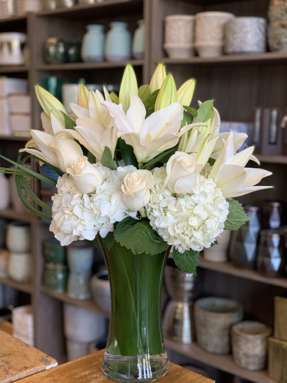 white lilies, roses, hydrangea giving it a modern style 