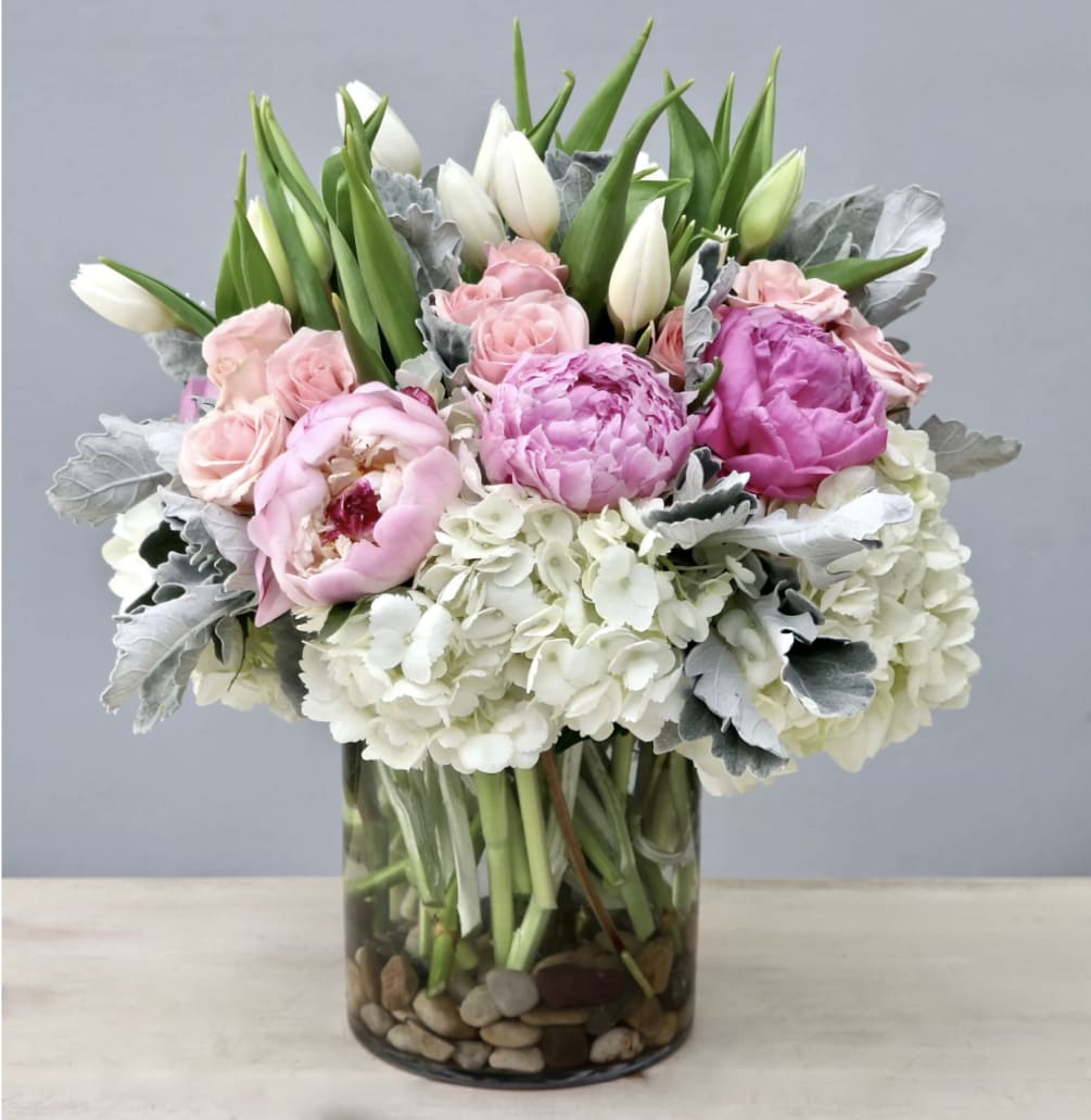 Tulips, peonies, roses, baby roses, veronicas, hydrangeas, and dusty miller leaves make