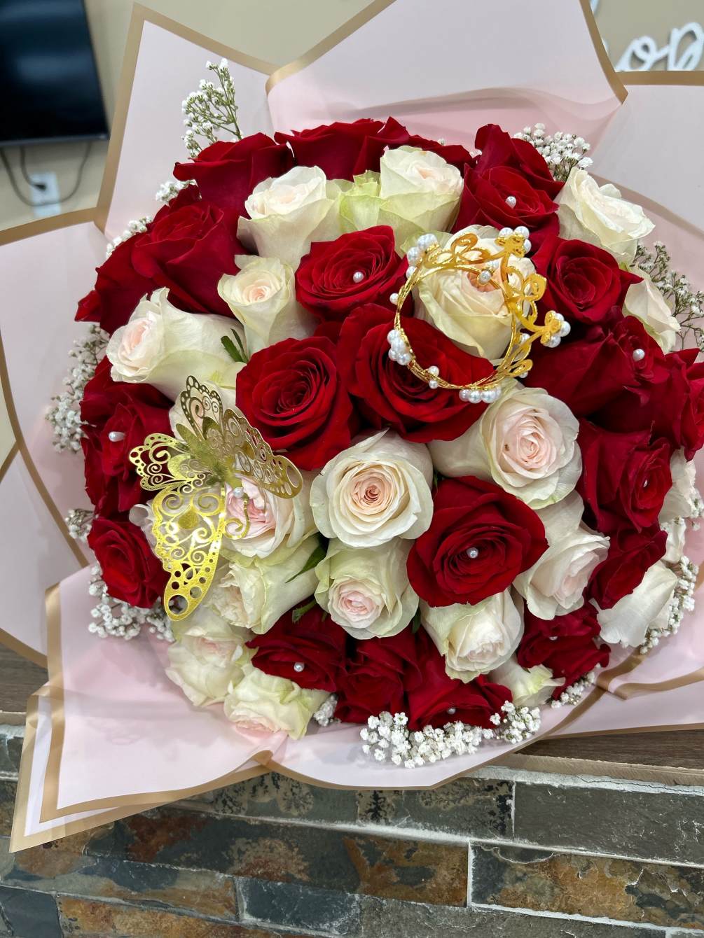 Beautiful red and light pink roses arranged in a handheld bouquet. 