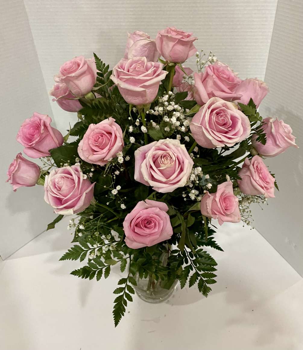 This arrangement, features two dozen exquisite pink roses. Each delicate bloom exudes