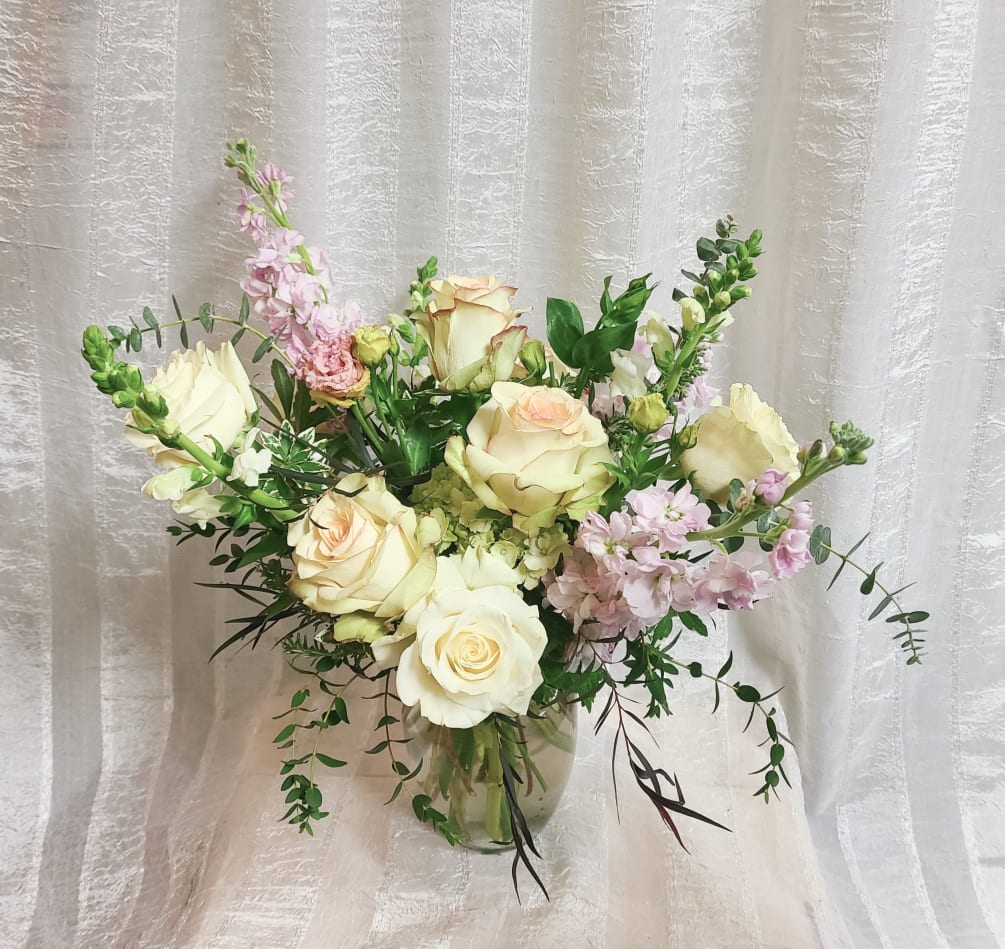 Romantic pastels and delicate scents. Half dozen roses with added mixed blooms.