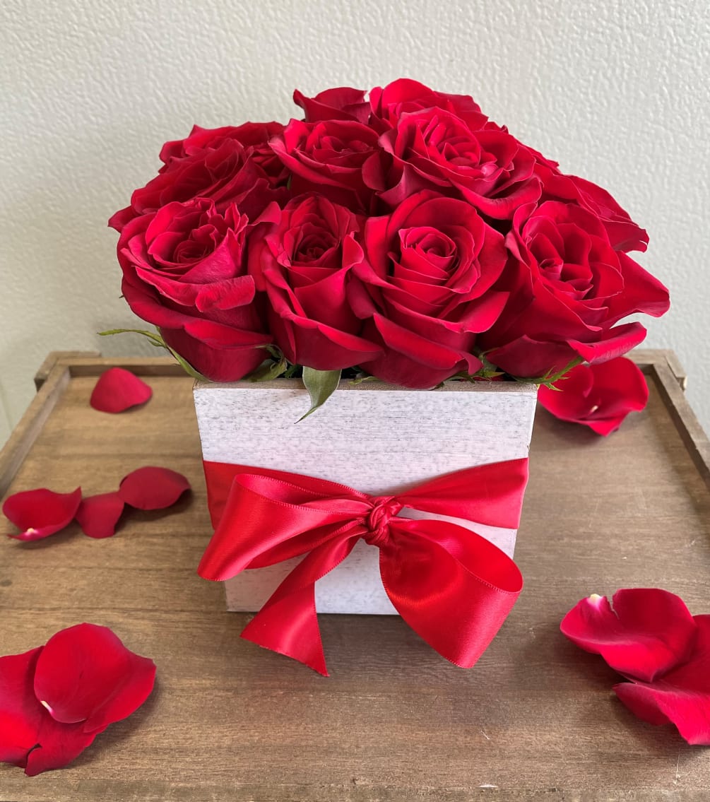 Send a dozen red roses, uniquely arranged in a white washed wood